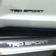 The black badge is on the driver’s door, and the other on the door sil.